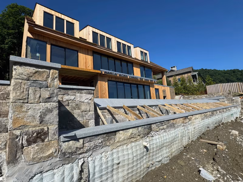 Custom poolside stonework and wall detailing at a high-end residential outdoor living space.