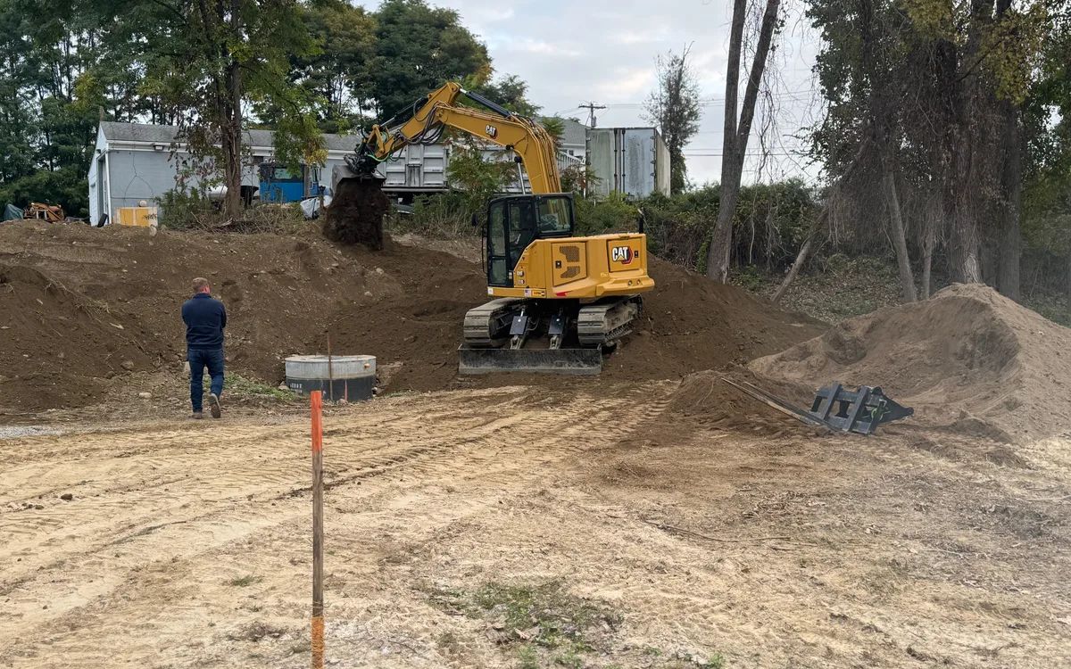 Excavator and graded site work area during an active excavation project.