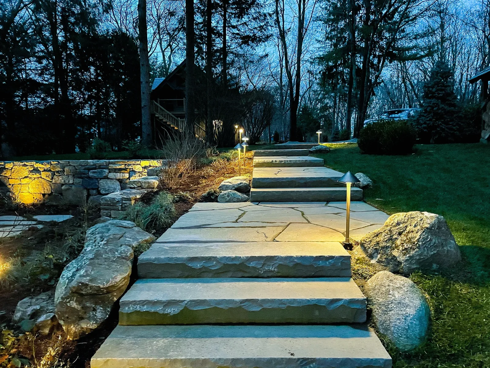 Stone steps and hardscape detailing with surrounding landscape work.
